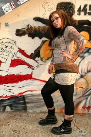 Adahlia in outside and she proudly flashes her inked torso