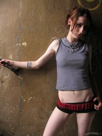 Skinny brunette strips and fondles her tiny tits while posing naked