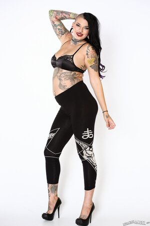 Tattooed girl with a fat ass and thick thighs getting naked