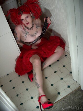 Fetish chick with flaming red hair spreads her chubby pussy wide in the bathroom