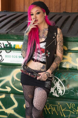 Kelsi Lynn shows off her petite ass and pussy beside the dumpster while smoking