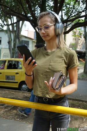 Veronica Leal poses on hood in green shirt and tight jeans