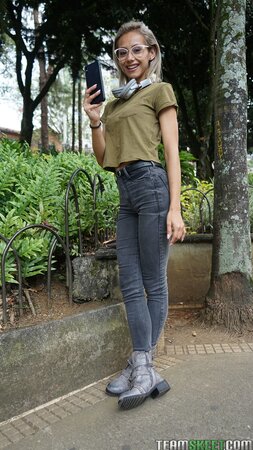 Veronica Leal poses on hood in green shirt and tight jeans