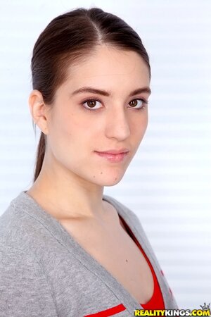 Cutie with ponytail takes off jeans and red top to impress guys with body