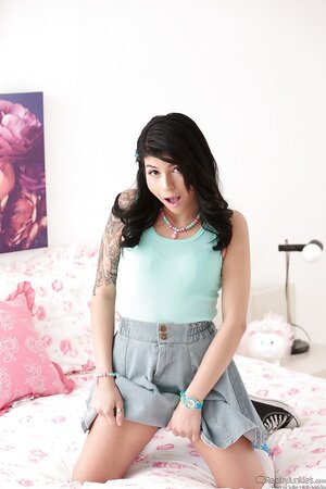Enticing Latina teen secludes herself in the bedroom to practice nudity