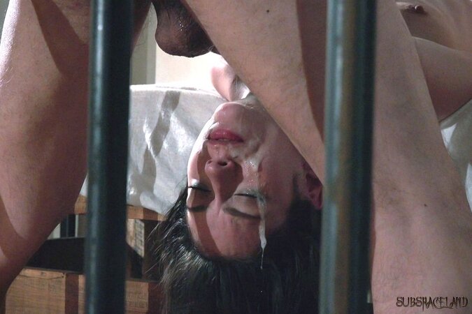Slender brunette facialized after fetish sex with master in strange prison cell
