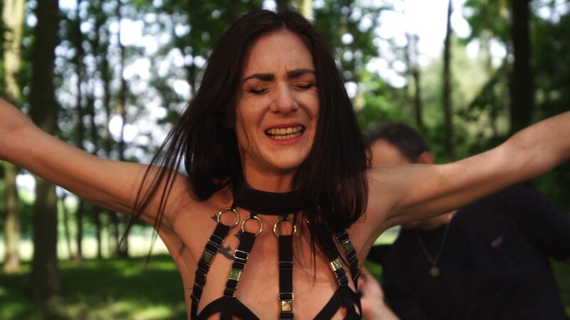 Submissive chick enjoys outdoor bondage domination performed by master