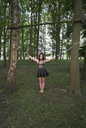 Submissive chick enjoys outdoor bondage domination performed by master