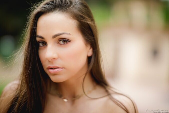 There is a tree and busty girl with beautiful face likes to pose naked by it