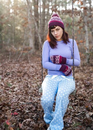 Female is alone on the swing and ignoring the weather she gets naked