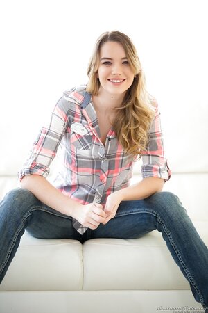 Slim beauty takes off jeans with intention to touch sweet cunny on sofa