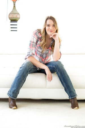 Slim beauty takes off jeans with intention to touch sweet cunny on sofa