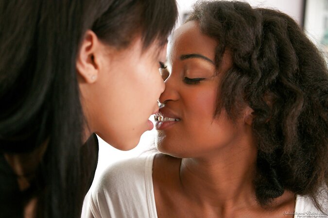 Chocolate teen drags comely GF in bedroom to have sensual lesbian sex