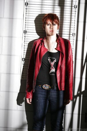 Bitchy rock-chick with red hair on head and pubis poses naked in police station