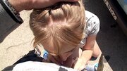 A cute thing gets on her knees in the street and then she does a blow job