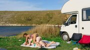 Tender beauties are passionately licking next to the lake