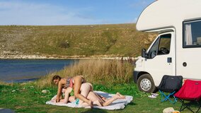Tender beauties are passionately licking next to the lake